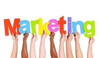 Multi-Ethnic Group Of People Holding The Word Marketing