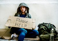Homeless woman with a please help sign