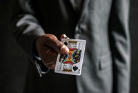 Closeup of a hand holding a playing card
