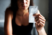 Woman holding condoms