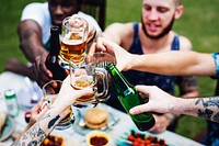 Group of diverse friends celebrating drinking beers together