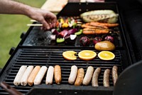 Closeup of sausageas cooking on charcoals