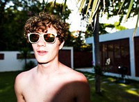Closeup of caucasian man wearing sunglasses enjoying summer time