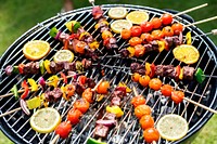 Group of diverse friends grilling barbecue outdoors