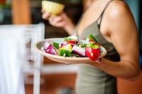 Closeup of hand holding vegetable barbecue plate