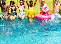 A diverse group of friends enjoying summer time by the pool with inflatable floats