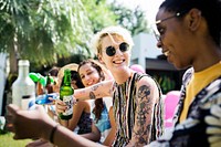 Group of diverse friends celebrating drinking beers together