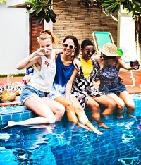 Group of girls friends hanging out on the pool
