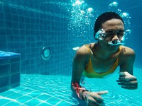 African descent woman underwater in swimming pool