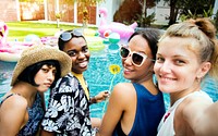 Group of diverse women taking selfie by the pool