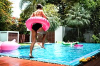 A girl jumping in to swimming pool