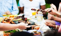 Group of people having BBQ party outdoors