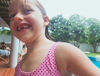 Closeup of caucasian girl standing alone by the pool