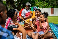 Black family enjoying summer together at backyard