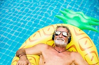 Closeup of caucasian senior man in the pool with headphones