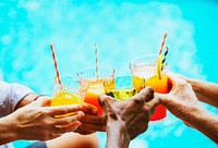 Closeup of diverse hands clinking drinks together