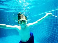 Closeup of caucasian boy underwater in the pool