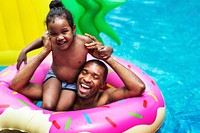African descent father and daughter in a pool