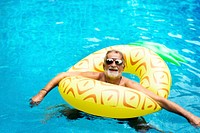Senior caucasian man floating in the pool with inflatable tube