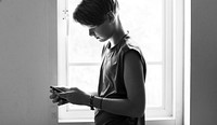 Young caucasian boy using mobile phone grayscale