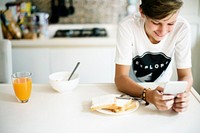 Young caucasian man using mobile phone in kitchen