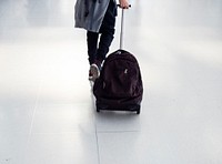 Young caucasian boy travel with luggage in the airport