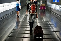 Young caucasian man travel with luggage in the airport