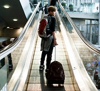 Young caucasian man travel with luggage in the airport