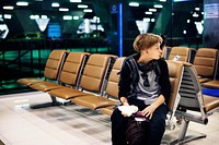 Young caucasian man sitting waiting at airport