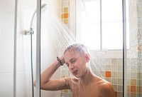 Young caucasian man showering in bathroom