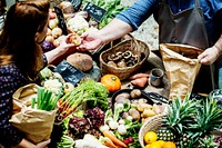 People buying fresh organic vegetable at market