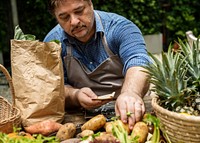 Hispanic man setting fresh vegetable at the market