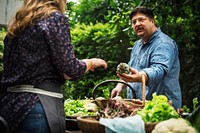 Man buying fresh organic vegetable at market