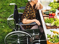 Side view of handicap senior woman on wheelchair outdoors