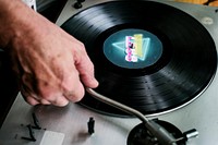 Hand playing vinyl on a player