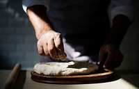 Hands preparing bread