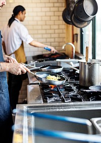 Chef stirring a spaghetti at a wok station