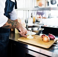 Chop onion by knife on a cutting board