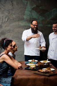 Chef explaining a dish to a customer