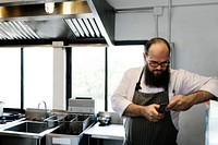 Man chef in the restaurant kitchen