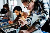 Technicians working on computer electronics parts