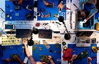 Aerial view of electronics technicians team working on computer parts