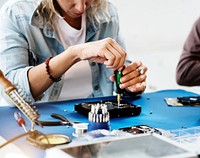 Technicians working on computer hard disk