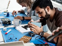 Electrical technicians working on electronics parts
