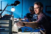 Technicians working on computer electronics parts