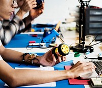 Side view of man working on robot