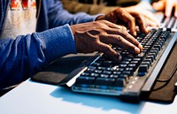 Closeup of hands working on computer keyboard