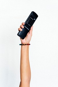 Hand holding remote control isolated on background