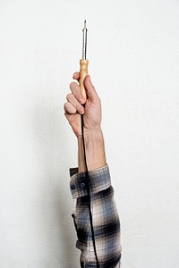 Hand holding equipment tool isolated on background