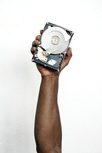 Hand holding hard disk drive isolated on background